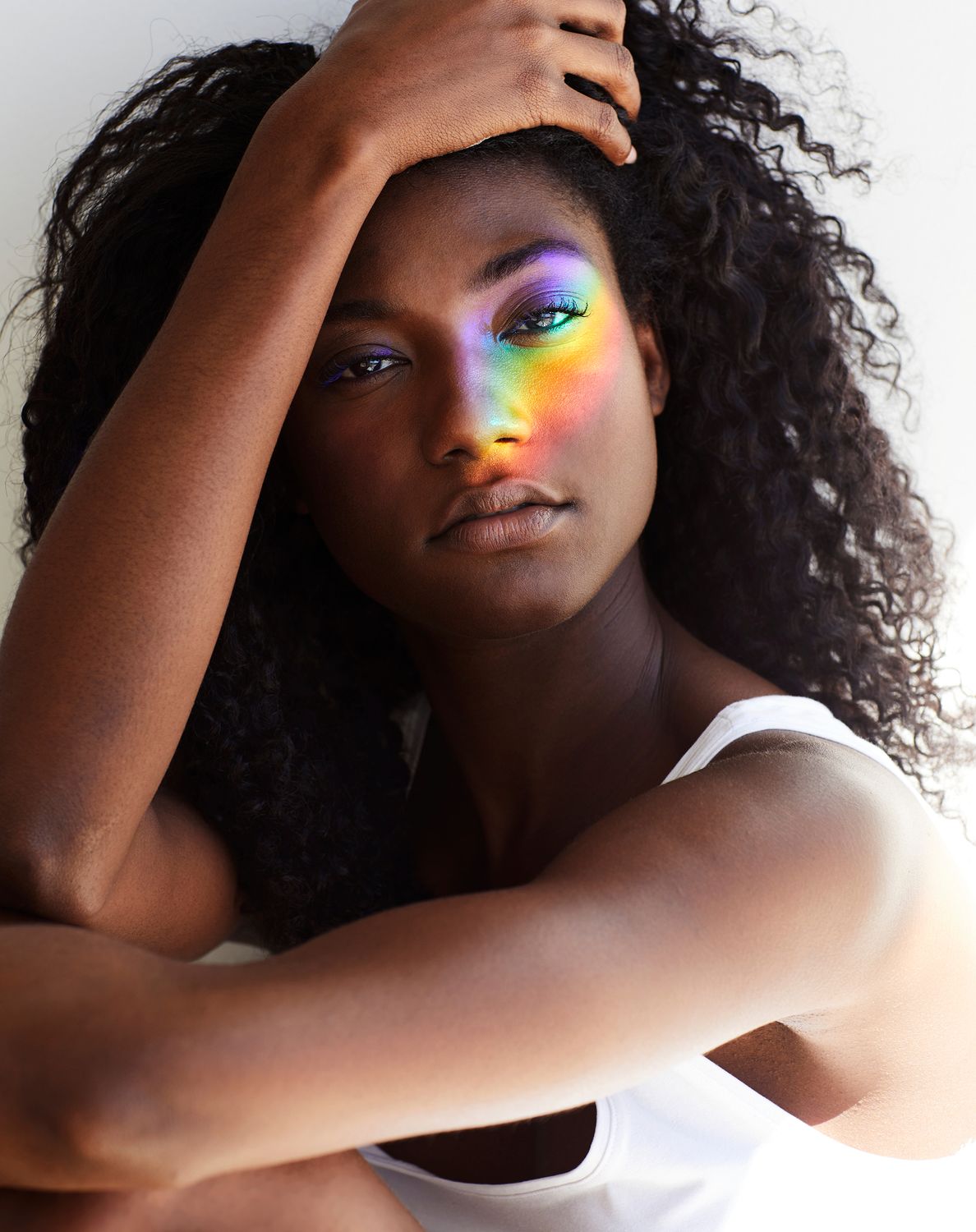 Person with rainbow light on their face.