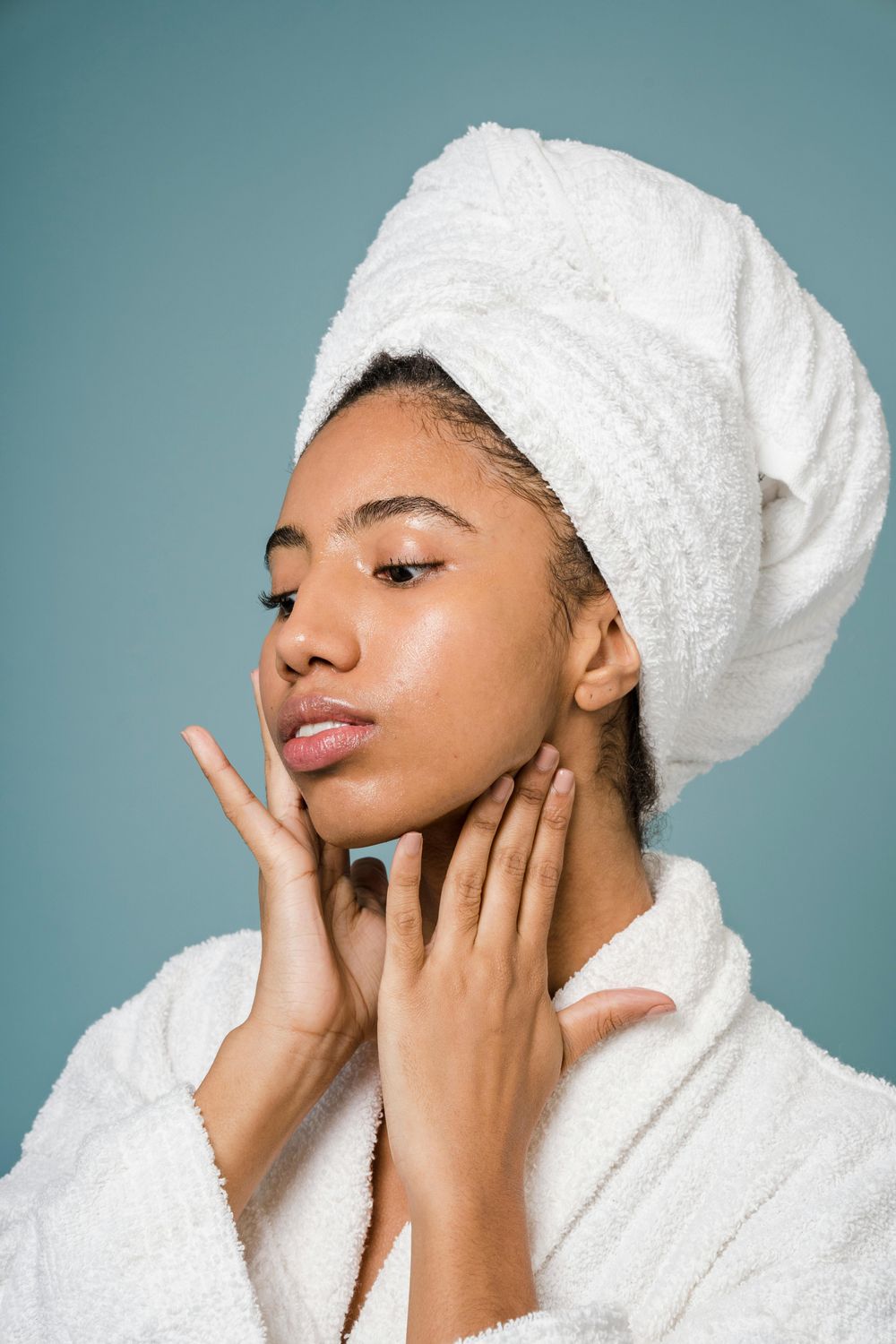 Woman in towel caring for her skincare routine.