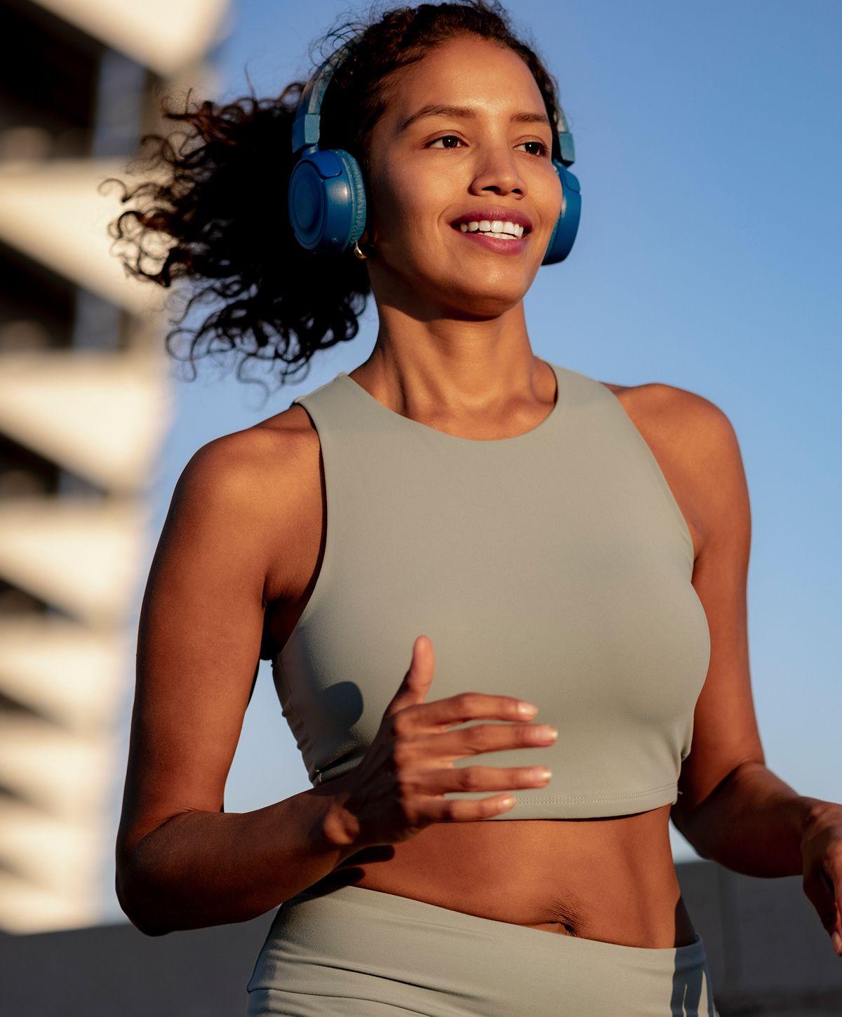 Woman jogging outdoors with headphones on